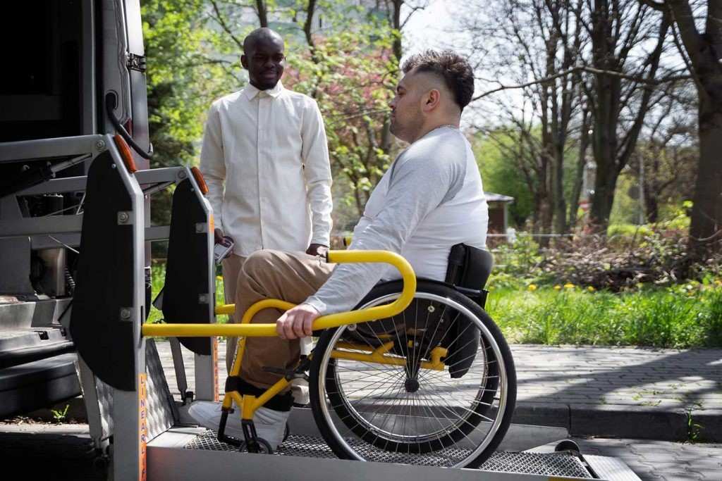 Young woman in a wheelchair smiling while receiving community care support.